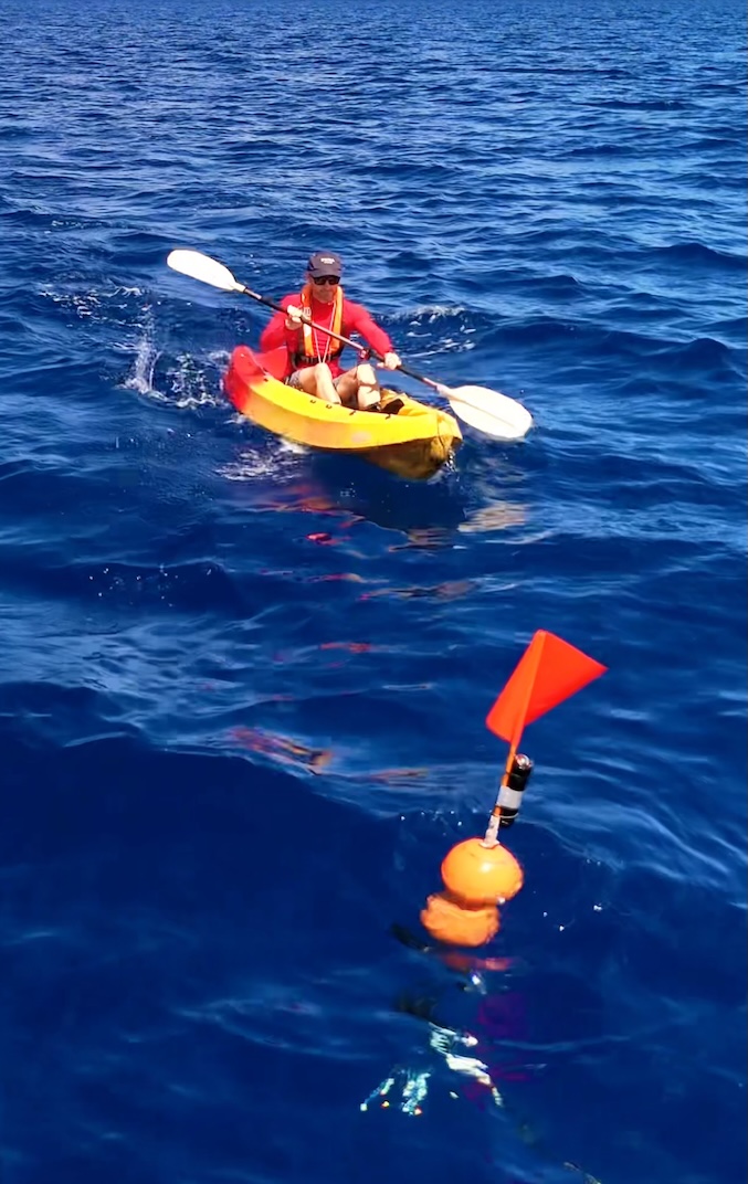Chris Bray kayaking out to a camera float off Christmas Island